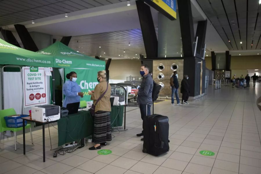 Reisende lassen sich am Flughafen in Johannesburg auf das Coronavirus testen.