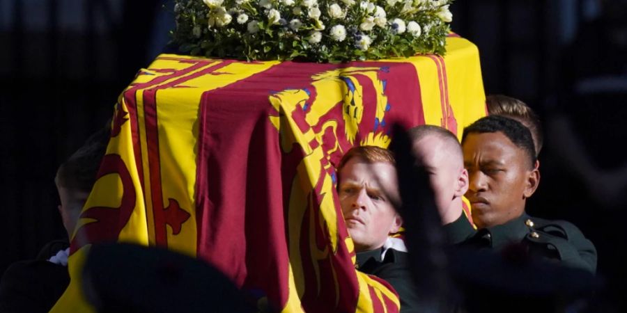 Sargträger tragen den Sarg von Königin Elizabeth II. aus der St.-Giles-Kathedrale. Ein Flugzeug mit dem Sarg soll um 19.00 Uhr (MESZ) vom Flughafen Edinburgh abheben und knapp eine Stunde später in der britischen Hauptstadt landen. Foto: Jacob King/PA Wire/dpa