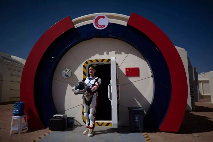 Eine chinesische Mitarbeiterin des Projekts, das für Fotos posiert. China C-Space Mars