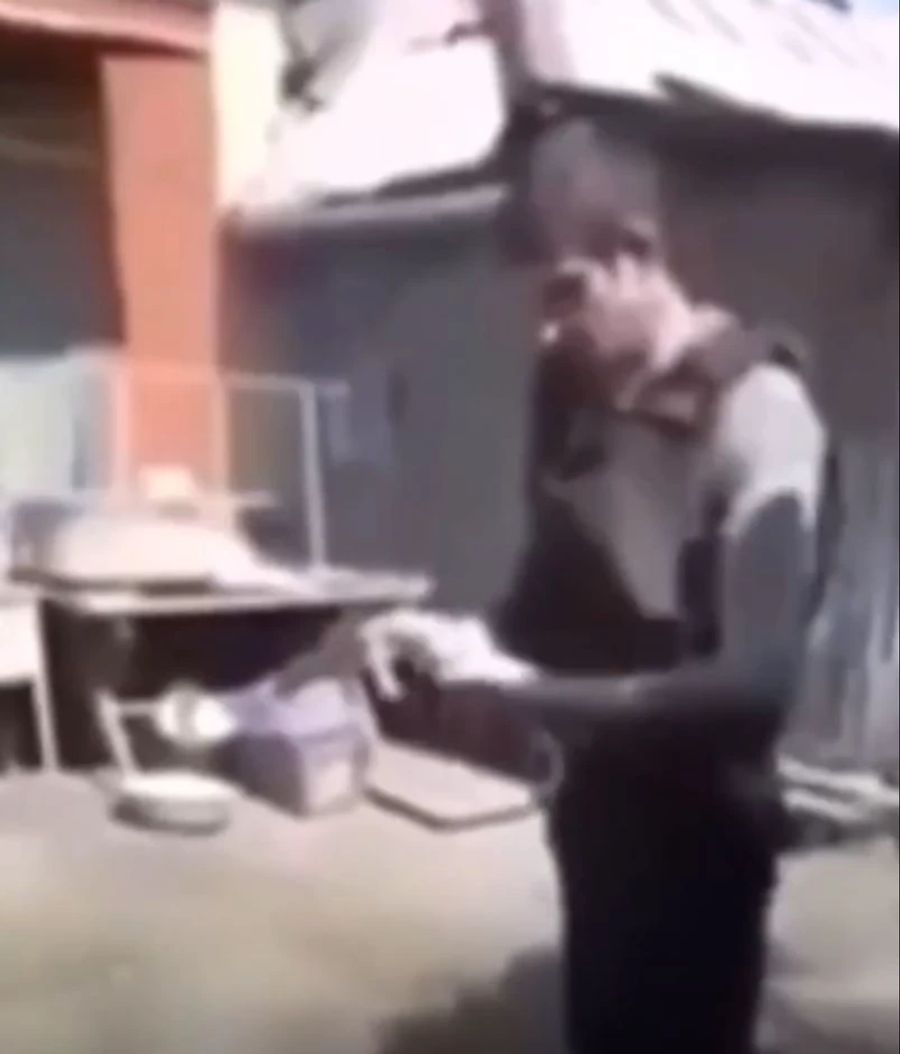 Ein russischer Soldat schiesst sich mit einer Pistole durch seine kugelsichere Weste in den Bauch.