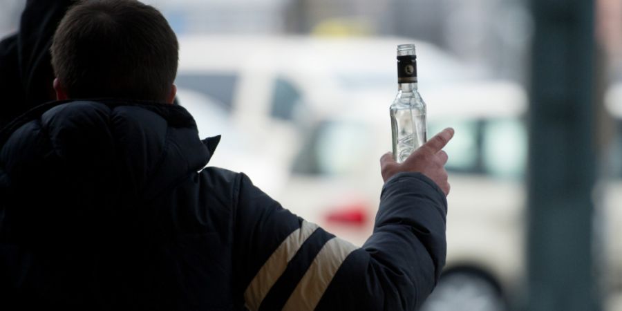 ARCHIV - Ein stark alkoholisierter Mann gestikuliert am Hauptbahnhof in Hamburg mit einer Wodkaflasche in der Hand. Foto: Daniel Reinhardt/dpa