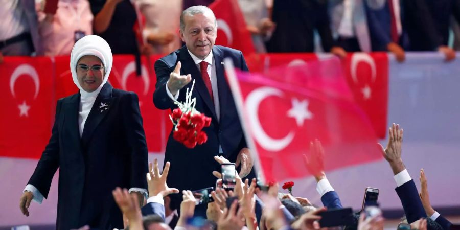 Recep Tayyip Erdogan, der türkische Staatspräsident, und seiner Frau Emine werfen ihren Unterstützern Blumen zu,