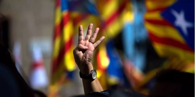 Ein Unterstützer der Unabhängigkeitsbestrebungen Kataloniens hält vier Finger als Zeichen für die vier Balken der Estelada-Flagge. Ein Unterstützer der Unabhängigkeitsbestrebungen Kataloniens hält vier Finger als Zeichen für die vier Balken der Estelada-Flagge.