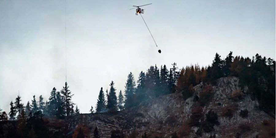 Hubschrauber des Air-Glaciers löschen den Waldbrand auf dem Kamm des Prabe über der Walliser Gemeinde Saviese.