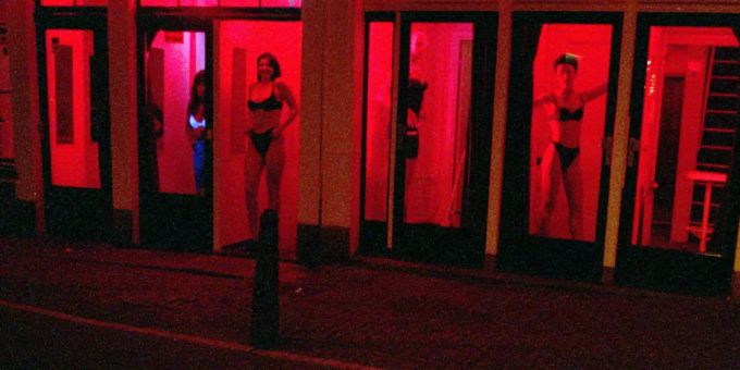 Prostitutes present themselves in the red light district of Amsterdam.