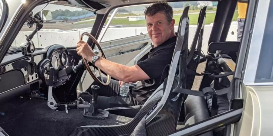 Mark Higgins in einem Aston Martin DB5 Stuntfahrzeug. Foto: Philip Dethlefs/dpa