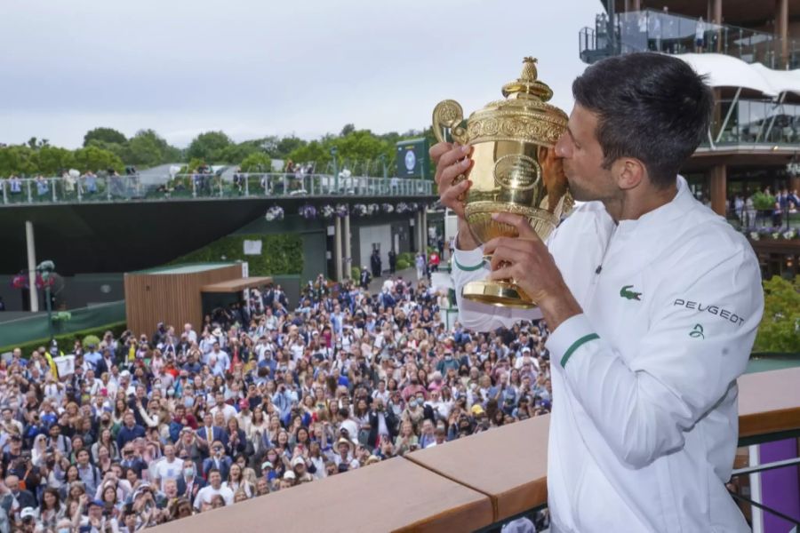 Djokovic gibt der Wimbledon-Trophäe ein Küsschen.