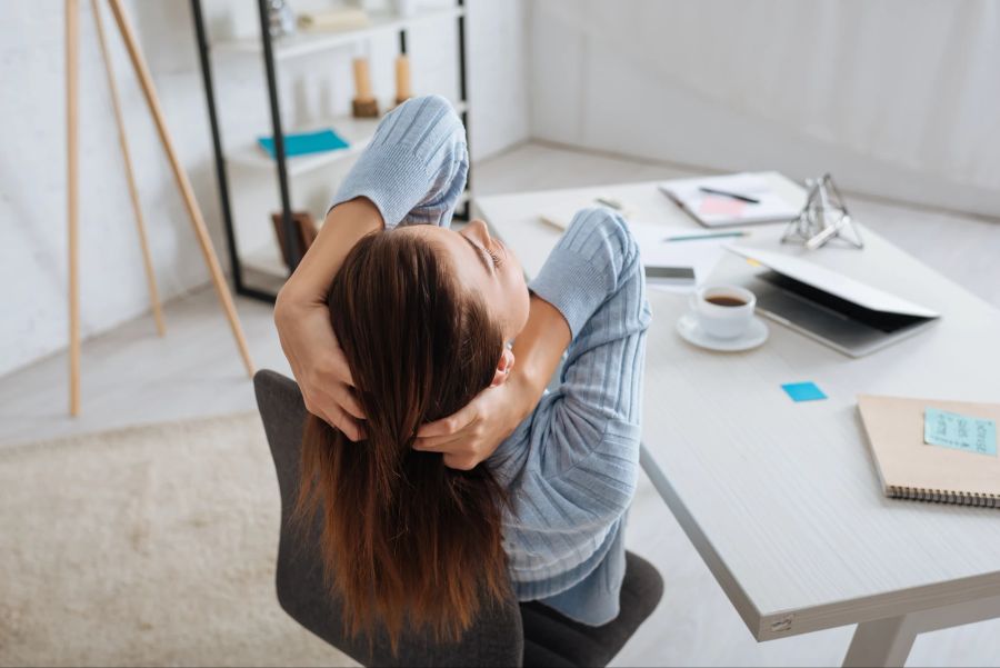Frau am Schreibtisch macht Pause