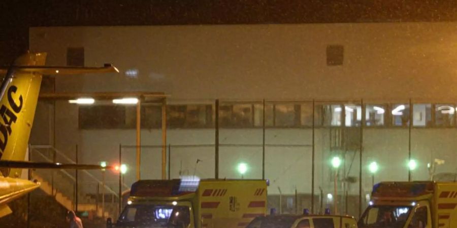 Zwei Rettungswagen mit Corona-Patienten, die nach Bremen ausgeflogen werden, stehen in der Nacht auf dem Flufhafen Dresden International. Foto: Robert Michael/dpa-Zentralbild/dpa