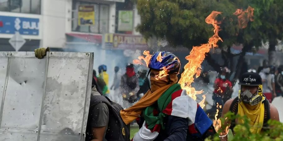 Ein Demonstrant in Cali wird von einem Molotow-Cocktail getroffen
