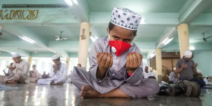 Ein muslimischer Junge trägt eine Maske während seines Gebets. (Symbolbild) ramadan who