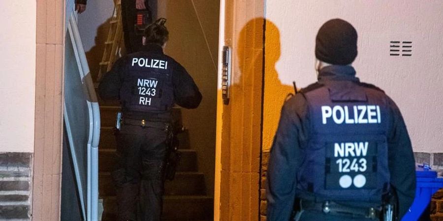 Einsatzkräfte der Polizei durchsuchen ein Mehrfamilienhaus in Essen. Foto: Justin Brosch/dpa