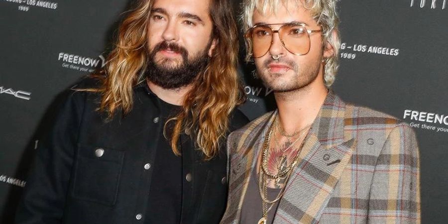 Verschieben ihre internationale Tournee: Tom Kaulitz (l) und sein Bruder Bill Kaulitz. Foto: Gerald Matzka/dpa