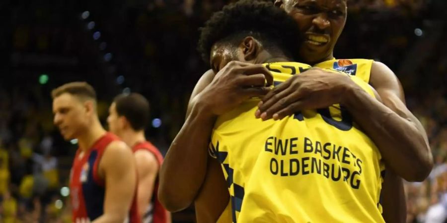 Oldenburgs Rickey Pulding (r) feiert mit Frantz Massenat den Sieg über Bayerns Baskteballer. Foto: Carmen Jaspersen