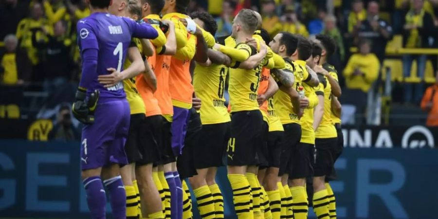 Die BVB-Spieler feiern nach dem Sieg gegen Wolfsburg mit ihren Fans die Rückkehr auf Platz eins. Foto: Ina Fassbender/dpa