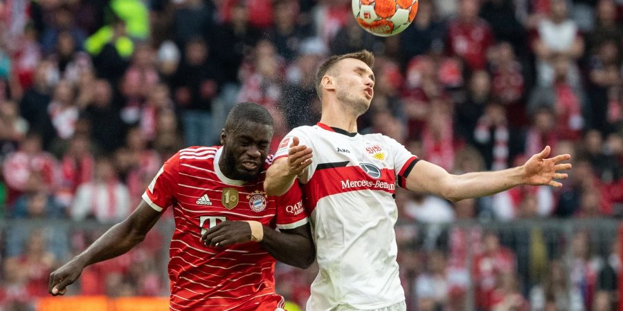 Dayot Upamecano vom FC Bayern München (l) und Sasa Kalajdzic von Stuttgart kämpfen im Kopfballduell um den Ball.