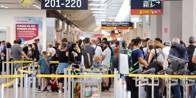 Passagiere stehen in einer Schlange von mehreren hundert Metern für die Sicherheitskontrolle am Flughafen Köln Bonn an. Passagiere stehen in einer Schlange von mehreren hundert Metern für die Sicherheitskontrolle am Flughafen Köln Bonn an.