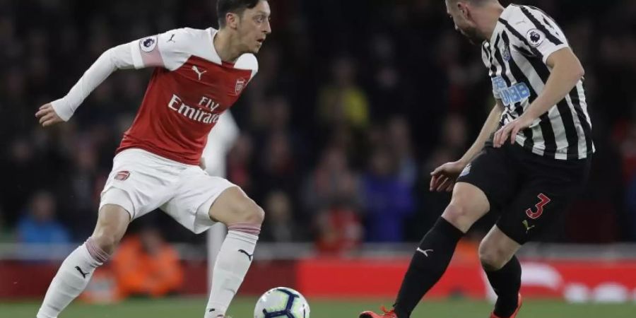 Mesut Özil (l) feierte mit seinem Team einen Heimsieg. Foto: Kirsty Wigglesworth/AP