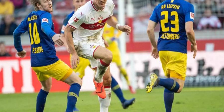 Stuttgarts Mario Gomez (M) kämpft gegen Leipzigs Emil Forsberg (l) und Marcel Halstenberg (r) um den Ball. Foto: Sebastian Gollnow