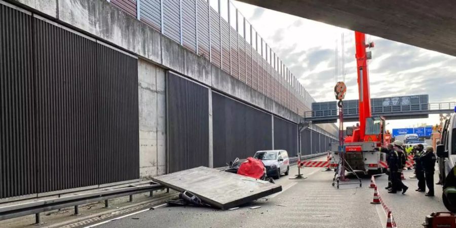 Eine grosse Betonplatte einer Lärmschutzwand ist auf der Autobahn 3 bei Köln auf einen Wagen gestürzt und hat eine Autofahrerin getötet. Foto: Feuerwehr Köln/dpa