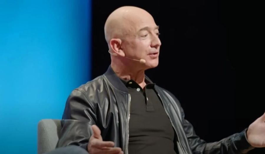 Amazon-Gründer Jeff Bezos trägt bei einem Vortrag eine Lederjacke.