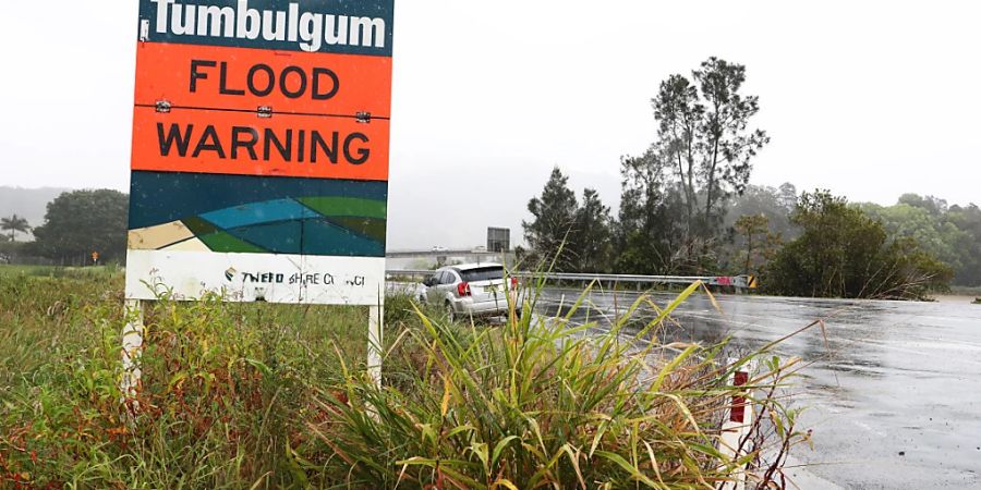 Flood signs at the town of Tumbulgum, NSW, Friday, September 23, 2022. The low-pressure storm system that caused flooding across inland NSW earlier this week tracked towards the coast, with flood and storm warnings covering much of the state's east. (AAP Image/Jason O'Brien) NO ARCHIVING