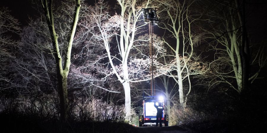 Polizisten beleuchten im Dunkeln einen Ort an einem Park in Pankow. Das vermisste vierjährige Mädchen aus Berlin ist tot. Es sei am Abend mit Verletzungen von Passanten im Bürgerpark Pankow gefunden worden, sagte ein Polizeisprecher.