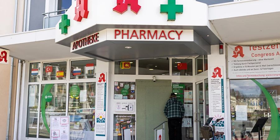 Ein Mann blickt durch das Fenster der Congress-Apotheke. Am Vorabend hat ein 20-jähriger Täter in der Karlsruher Congress-Apotheke mehrere Geiseln genommen. Kurz nach 21 Uhr haben dann Spezialkräfte der Polizei die Apotheke betreten und den Mann festgenommen. Foto: Philipp von Ditfurth/dpa
