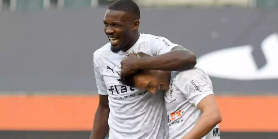 Mönchengladbachs Marcus Thuram (l) bejubelt sein Tor zum 2:0 mit Hannes Wolf. Foto: Bernd Thissen/dpa