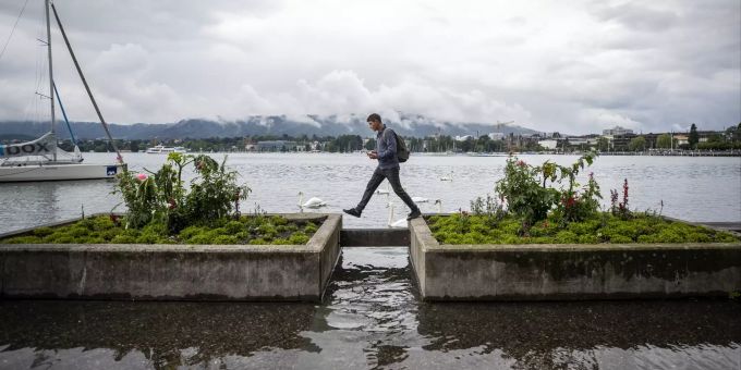 Aufgrund der heftigen Regenfaelle ist der Zuerichsee beim Bellevue ueber die Ufer getreten, aufgenommen am Freitag, 16. Juli 2021. (KEYSTONE/Alexandra Wey) ZUERICHSEE, HOCHWASSER, REGEN, UNWETTER, STURM, SEE, UEBERSCHWEMMUNG,