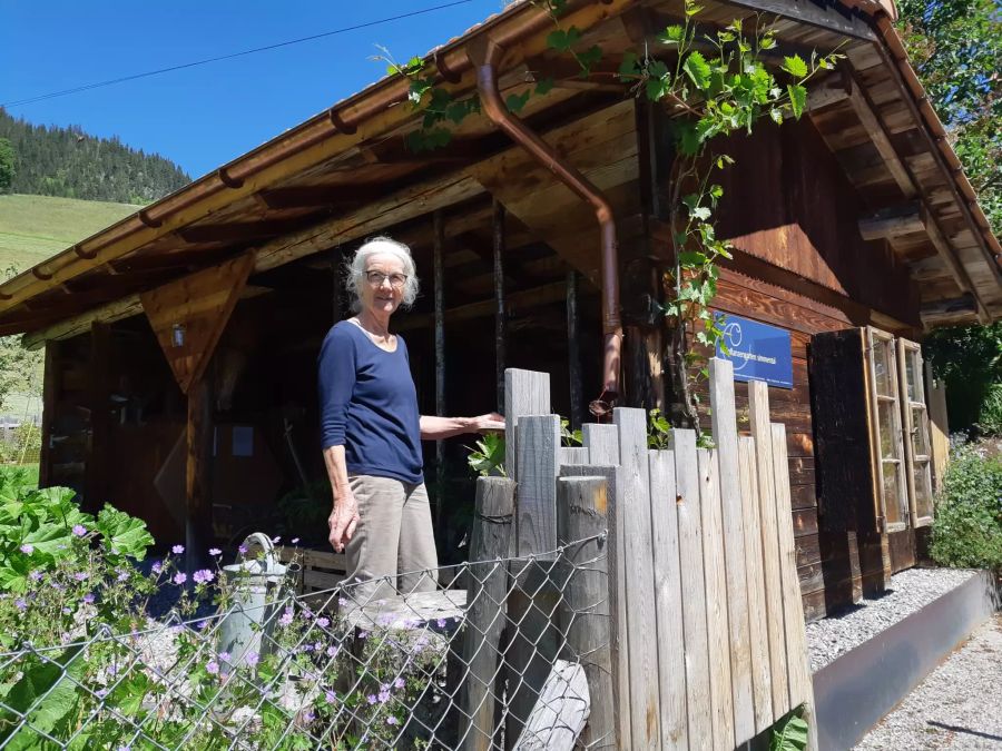 Alte Frau vor Hütte