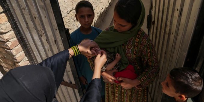 Einem Kind in Afghanistan wird eine Schluckimpfung gegen Polio verabreicht. afghanistan polio