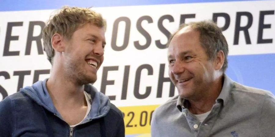 Sebastian Vettel (l) im Gespräch mit Gerhard Berger. Foto: Hans Klaus Techt/APA/dpa