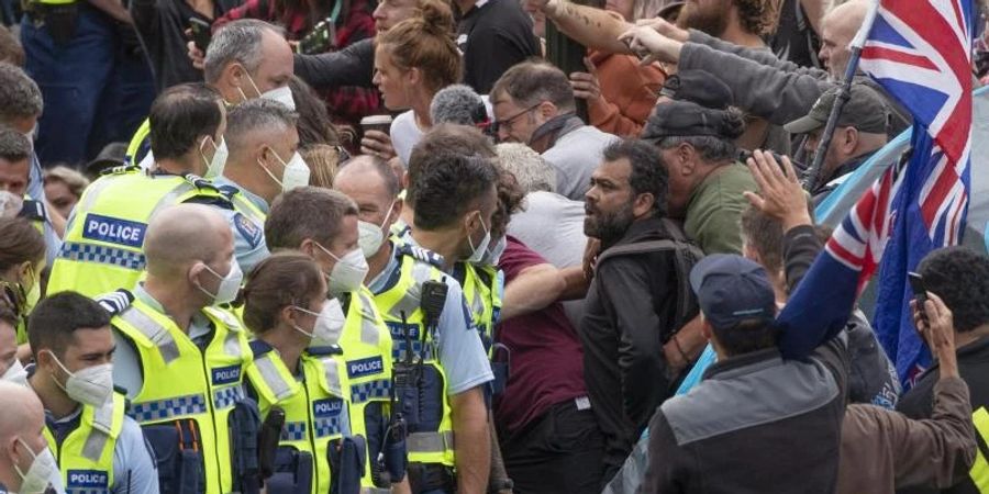 Die Polizei nimmt Menschen fest, die vor dem Parlament im neuseeländischen Wellington gegen eine Coronavirus-Impfpflicht protestieren. Foto: Mark Mitchell/NZME via AP/dpa