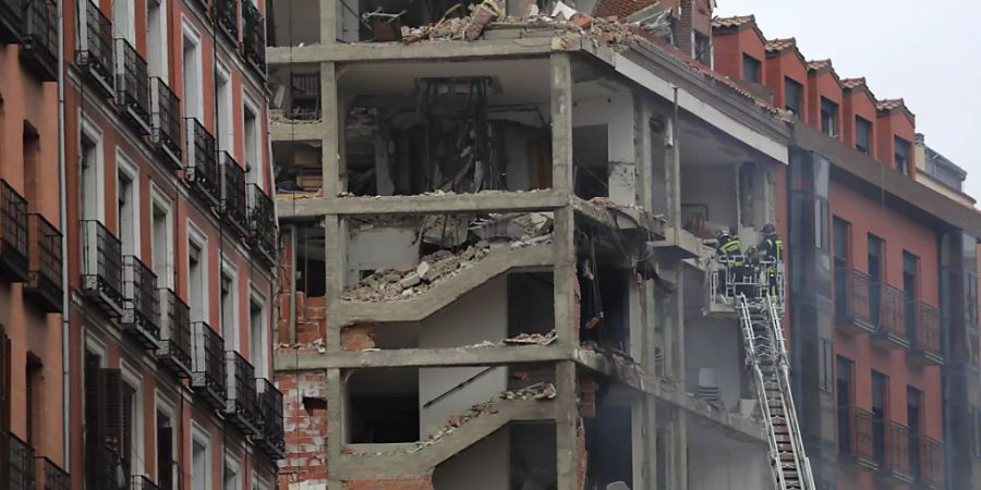 Feuerwehrleute arbeiten an dem beschädigten Gebäude in der Toledo Strasse in Madrid. Foto: Manu Fernandez/AP/dpa