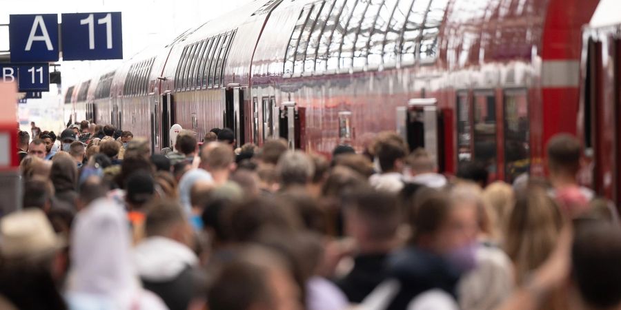 Fahrgäste stehen dicht gedrängt am Frankfurter Hauptbahnhof an einer Regionalbahn.