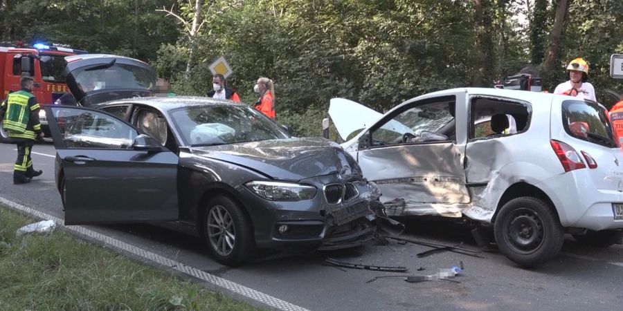 Rettungskräfte stehen nach einem Unfall an zwei verbeulten Autos. Die Zahl der Verkehrsunfälle ist in diesem Jahr deutlich gestiegen.