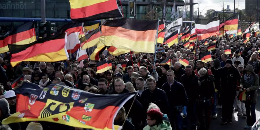 Teilnehmer der rechtspopulistischen Demonstration «Tag der Nation» des Bündnisses «Wir für Deutschland» ziehen mit Deutschlandfahnen durch Berlin.