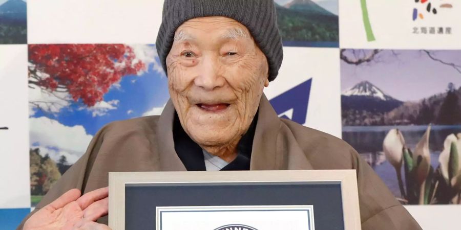 Masazo Nonaka hält ein Zertifikat von Guiness World Records