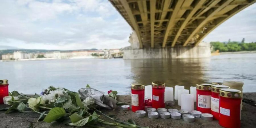 Kerzen und Blumen sind unter der Margaretenbrücke platziert. Die Kollision fand in der Nähe der Brücke statt. Foto: Zoltan Balogh/MTI/AP