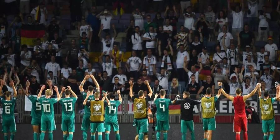 Die Nationalmannschaft lässt sich nach dem Spiel von den mitgereisten Fans feiern. Foto: Marius Becker