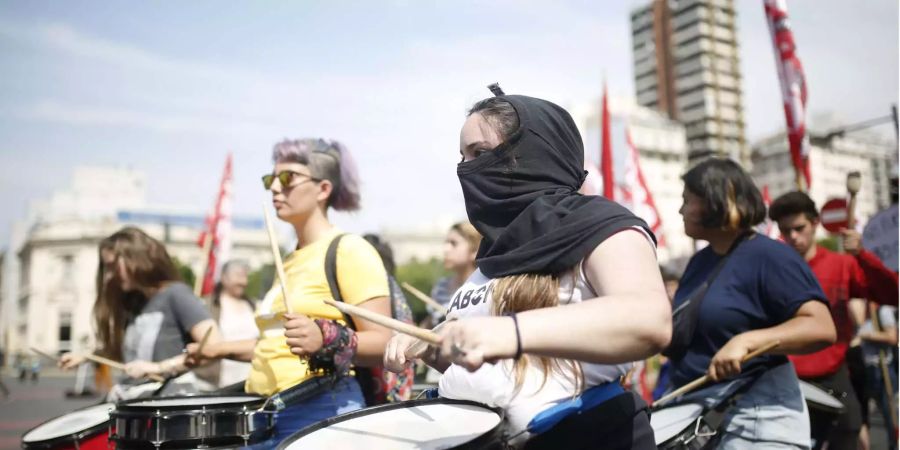 Junge Menschen spielen Trommel bei einem Protest gegen den G20-Gipfel.