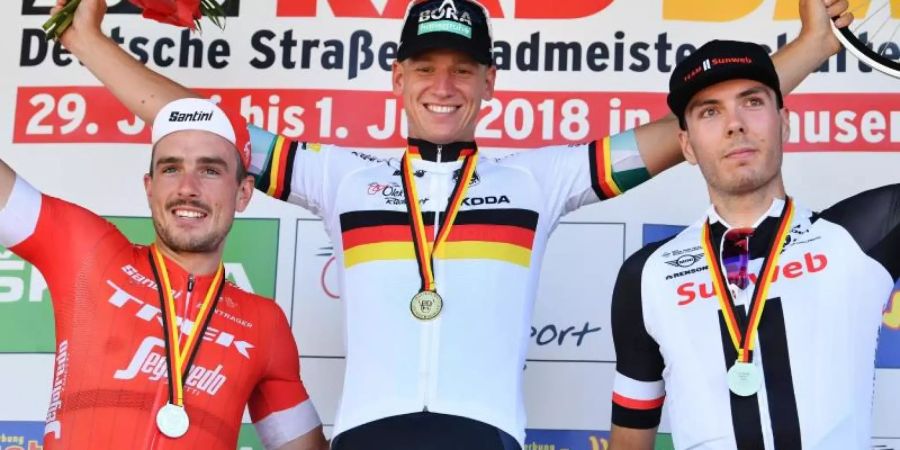Pascal Ackermann (M) sicherte sich 2018 in Einhausen den deutschen Strassenmeistertitel. Foto: Uwe Anspach/dpa