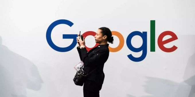 Handynutzerin vor Google-Logo Handynutzerin vor Google-Logo