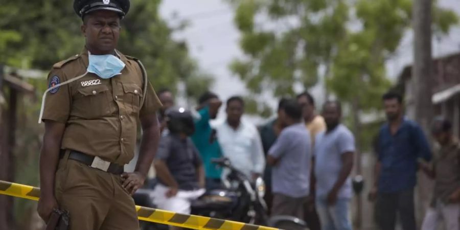 Ein Polizist bewacht einen Tatort in Kalmunai. Nach den verheerenden Osteranschlägen in Sri Lanka hat sich der IS auch zum jüngsten Blutvergiessen an der Ostküste des Landes bekannt. Foto: Gemunu Amarasinghe/AP