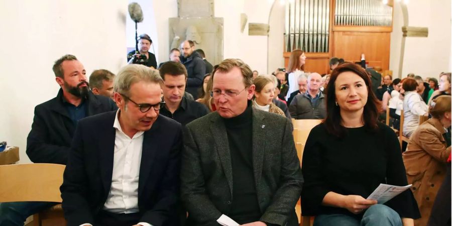 Georg Maier, Innenmininster von Thüringen, Bodo Ramelow, Ministerpräsident von Thüringen, und Anja Siegesmund, Ministerin für Umwelt, Energie und Naturschutz des Freistaates, sitzen bei einem Friedensgottesdienst in Apolda (D).