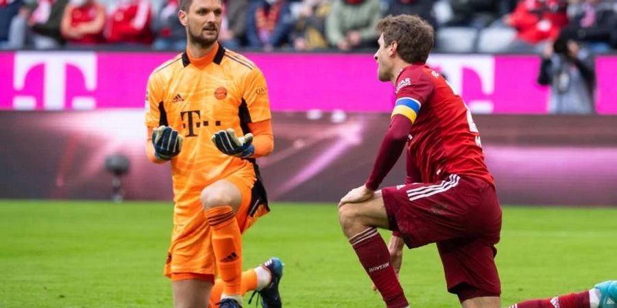 Thomas Müller (r) und Torwart Sven Ulreich von Bayern München knien nach dem Eigentor von Müller auf dem Rasen. Foto: Sven Hoppe/dpa