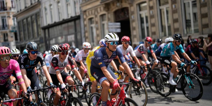 Musste wegen eines positiven Corona-Tests bei der Tour aussteigen: Max Walscheid (vorn,M,roter Helm) in Aktion.