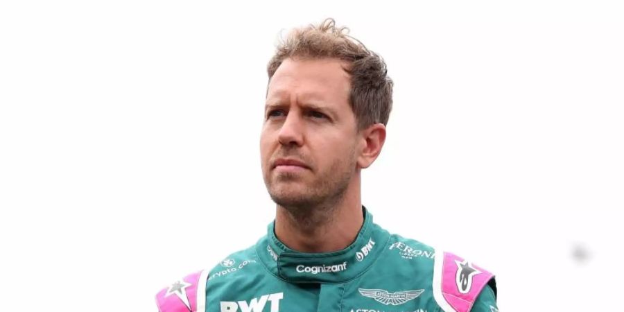 Aston Martin-Pilot Sebastian Vettel steht mit nachdenklicher Miene im Fahrerlager. Foto: Bradley Collyer/PA Wire/dpa