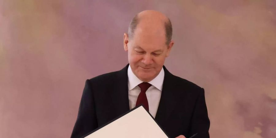 Bundeskanzler Olaf Scholz mit seiner Ernennungsurkunde.